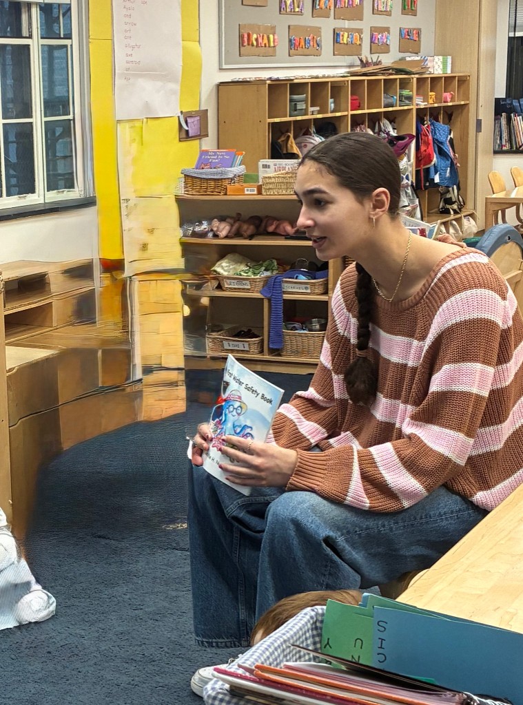 Educator reading a water safety book to children in a preschool classroom